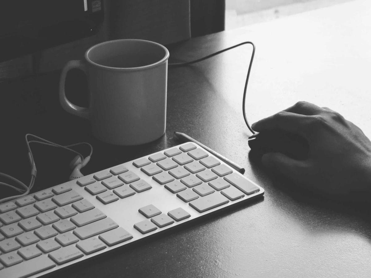 Placeholder photograph of a keyboard and coffee cup on a desk.